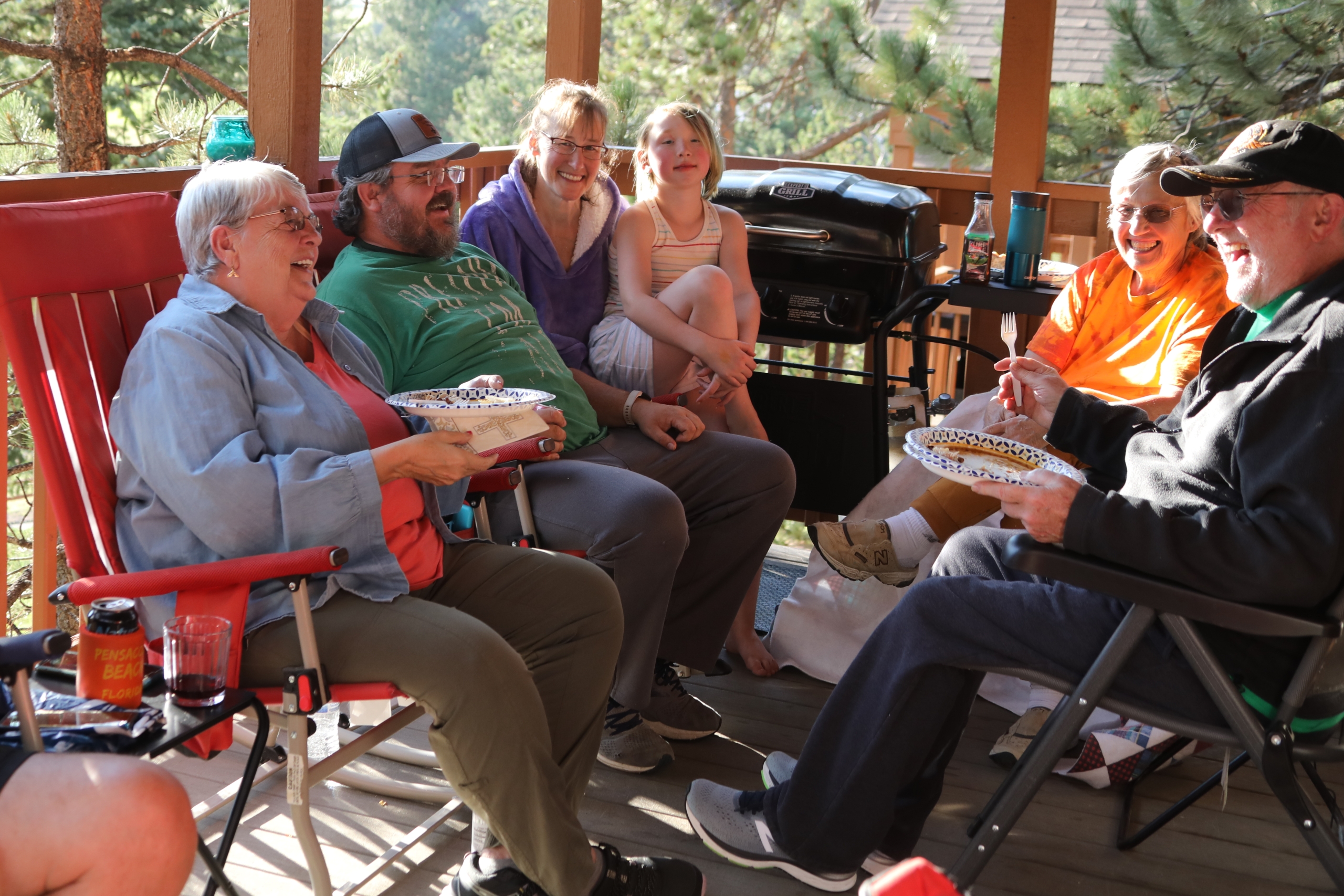 Group of adults on a porch laughing together