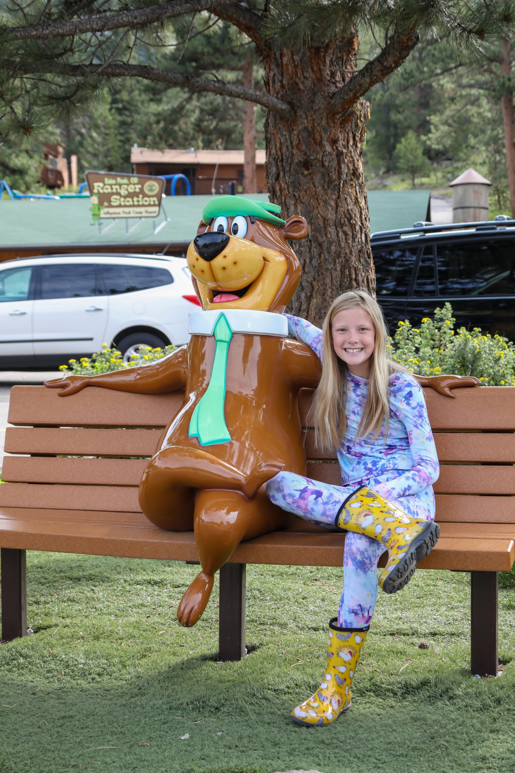 Camper on a bench with the Yogi Bear statue